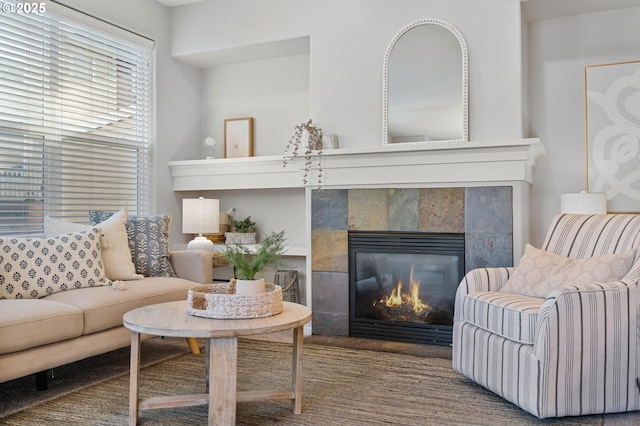 living area with a tiled fireplace