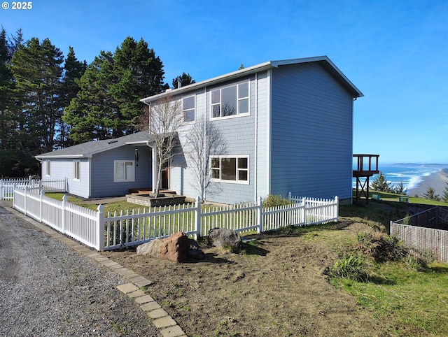 220 Flake St, Port Orford, OR 97465 - rear view of property with a fenced front yard and a water view