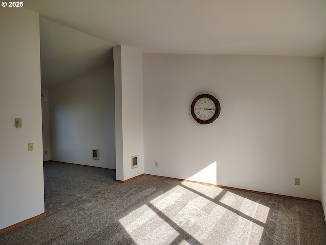 spare room featuring carpet, visible vents, and baseboards