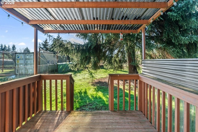 wooden terrace with a lawn and a trampoline