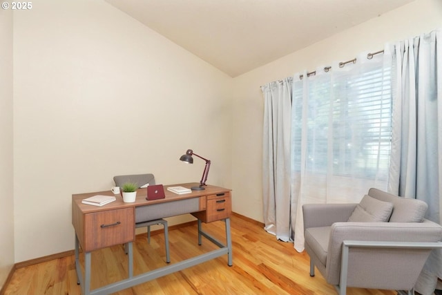 office space with hardwood / wood-style floors and vaulted ceiling