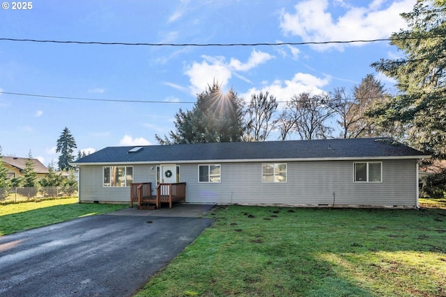 ranch-style home with a front lawn