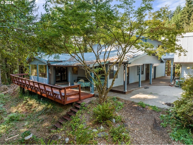 back of house featuring metal roof and a patio area