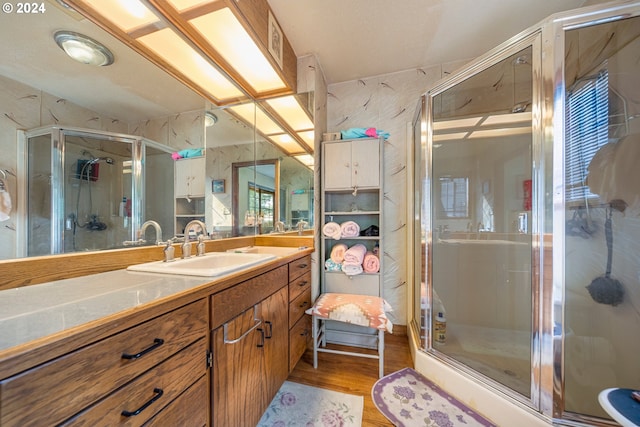 bathroom featuring hardwood / wood-style floors, vanity, and an enclosed shower