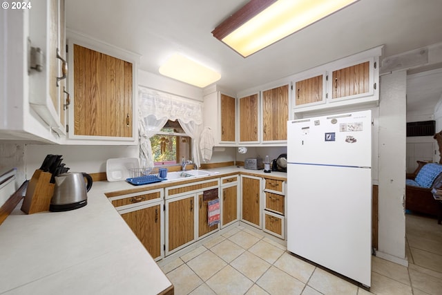 kitchen with white refrigerator and light tile patterned flooring