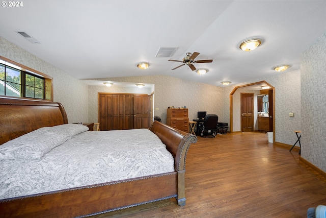 bedroom featuring hardwood / wood-style flooring, ceiling fan, and lofted ceiling