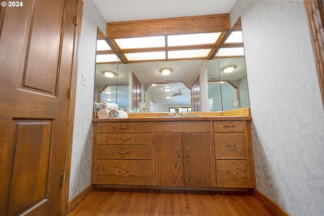 bathroom featuring vanity, beam ceiling, wood-type flooring, and coffered ceiling