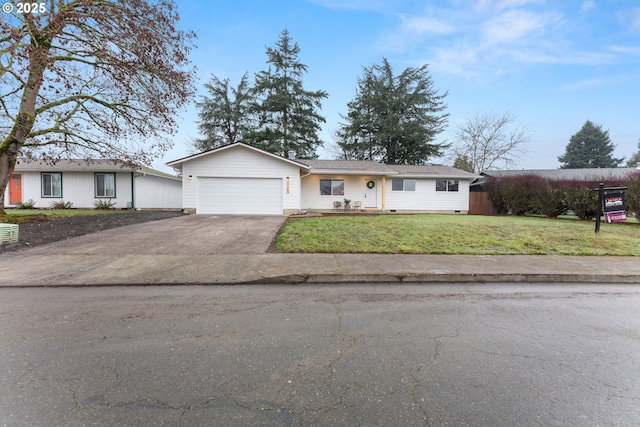 ranch-style home featuring a front lawn and a garage