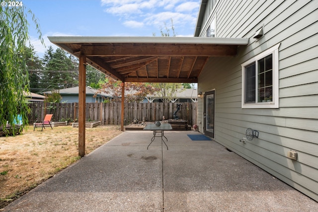 back of house featuring a lawn, french doors, a patio, and a fire pit