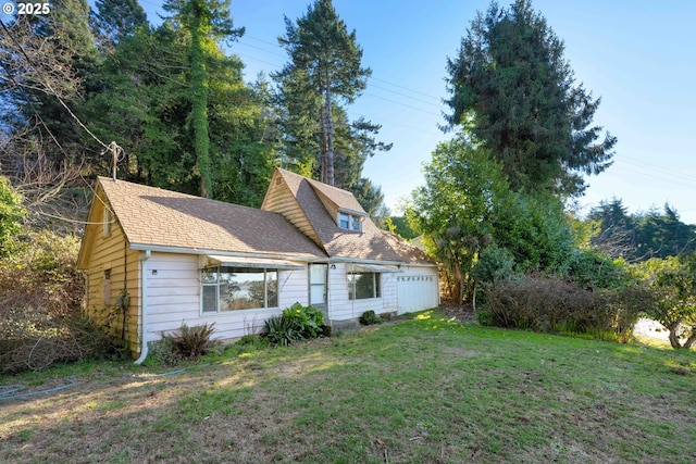 rear view of house featuring a lawn