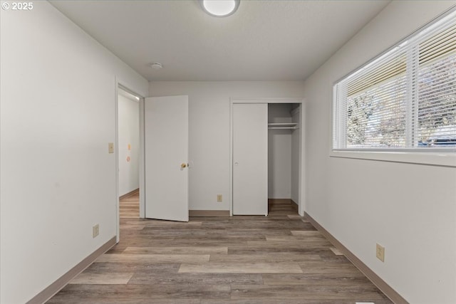 18765 SW Kinnaman Rd, Beaverton, OR 97078 - unfurnished bedroom featuring a closet, wood finished floors, and baseboards