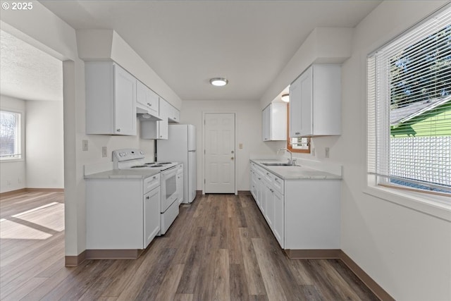 18765 SW Kinnaman Rd, Beaverton, OR 97078 - kitchen with white appliances, a sink, baseboards, and dark wood-style flooring