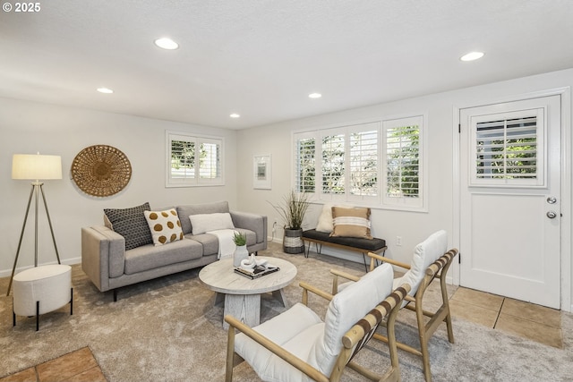 living area featuring light tile patterned floors, light colored carpet, and recessed lighting