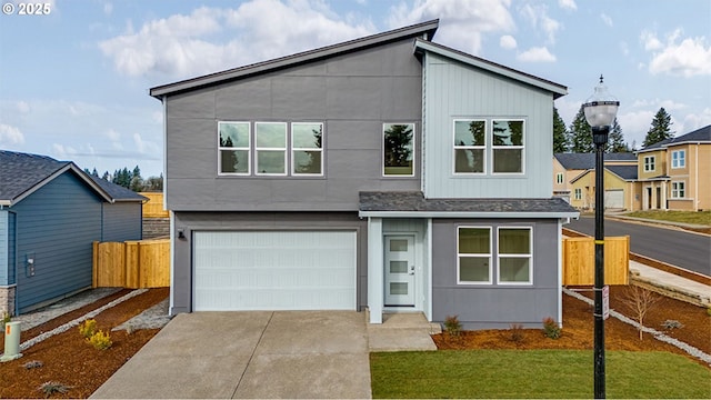 contemporary home featuring a garage and a front yard