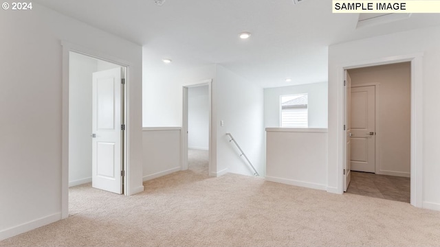 empty room with carpet floors, baseboards, and recessed lighting