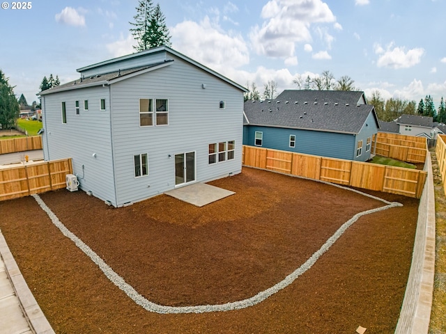 rear view of property with a fenced backyard