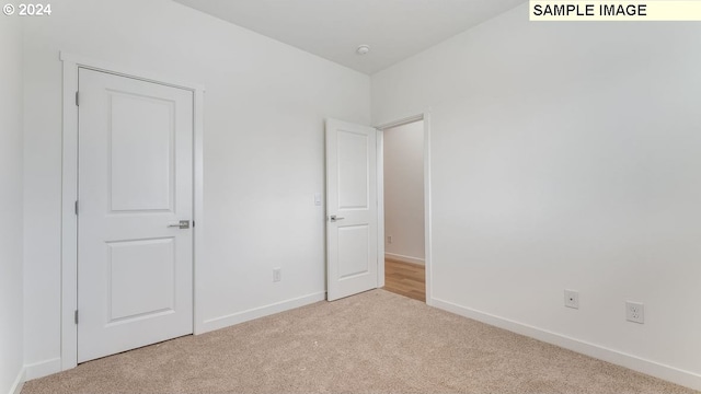 unfurnished bedroom with baseboards and carpet flooring