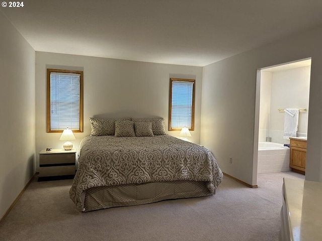 bedroom with light carpet, connected bathroom, and baseboards