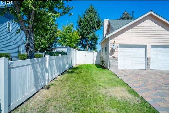 view of side of property with a yard and a garage