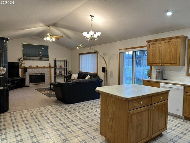 kitchen featuring a fireplace, ceiling fan with notable chandelier, dishwasher, a kitchen island, and lofted ceiling