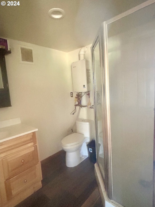 211 Jensen Quarry Rd, Bickleton, WA 99322 - full bathroom featuring visible vents, toilet, vanity, water heater, and a stall shower