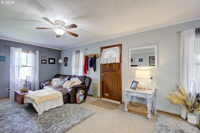 bedroom with crown molding, carpet floors, a textured ceiling, and ceiling fan