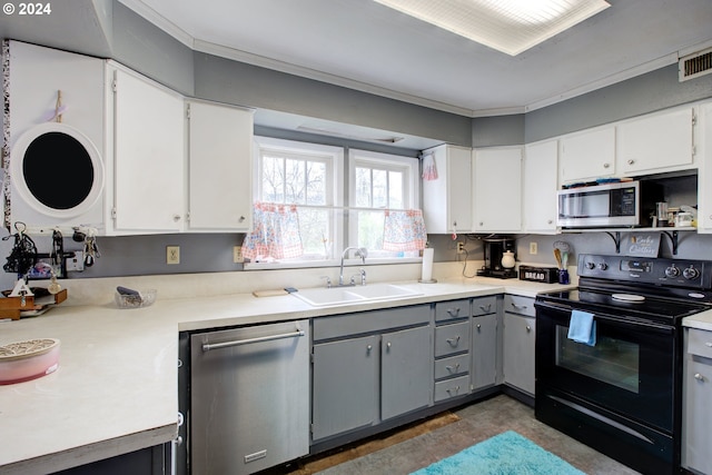 kitchen with white cabinets, stainless steel appliances, sink, and gray cabinetry