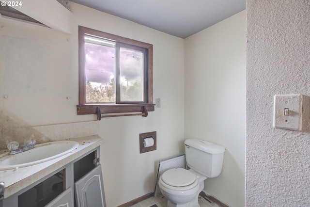 bathroom featuring vanity and toilet