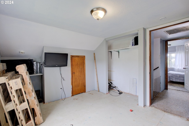 bedroom featuring lofted ceiling and a closet