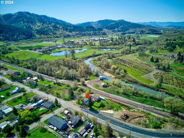 drone / aerial view with a water and mountain view