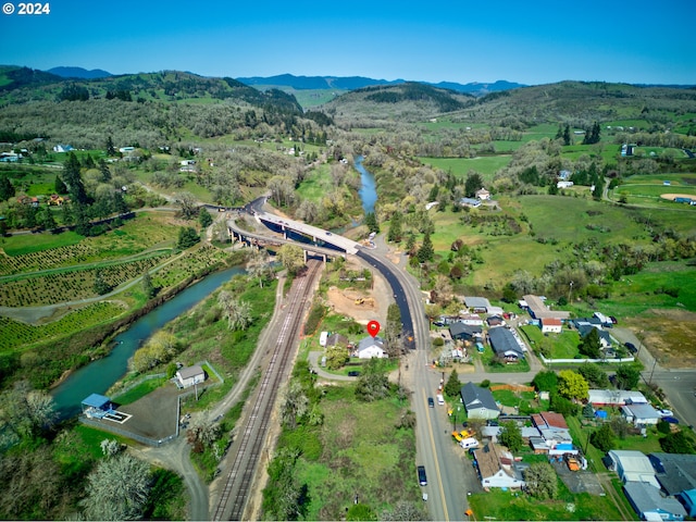 drone / aerial view with a water and mountain view