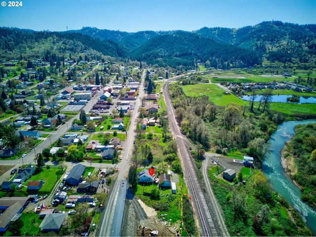 drone / aerial view with a water and mountain view