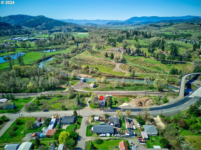 bird's eye view with a water and mountain view