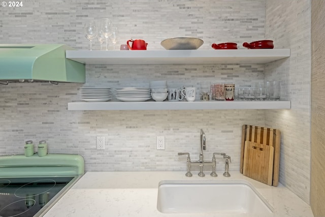 bar featuring backsplash and sink