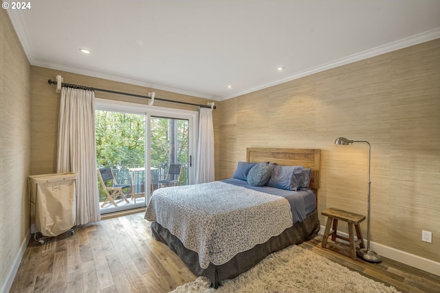 bedroom with access to exterior, crown molding, and hardwood / wood-style flooring