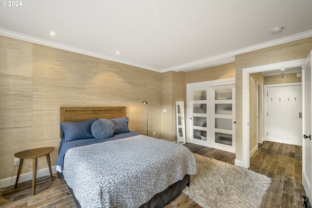 bedroom featuring crown molding and dark wood-type flooring