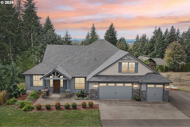 view of front of home featuring a lawn and a garage