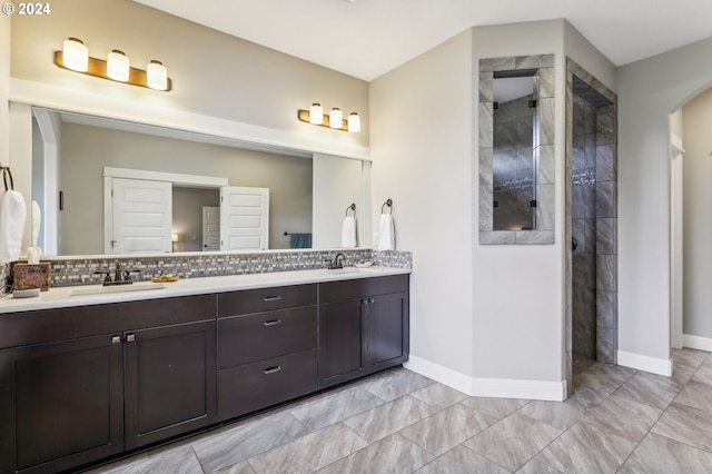 bathroom featuring tasteful backsplash, vanity, and walk in shower