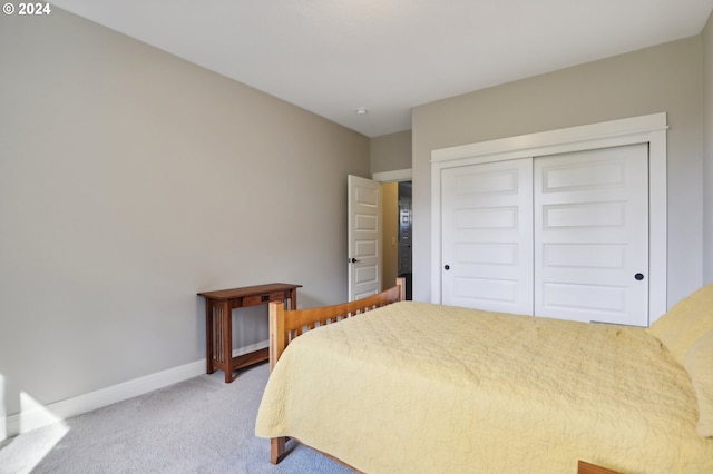 bedroom featuring light carpet and a closet