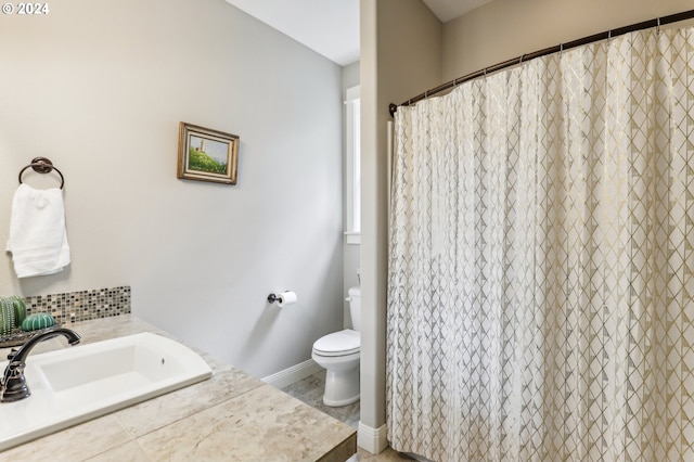 bathroom with vanity, a shower with shower curtain, and toilet