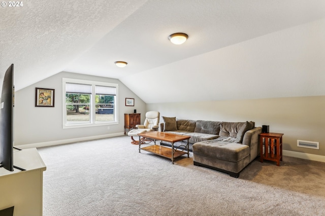 carpeted living room with lofted ceiling and a textured ceiling