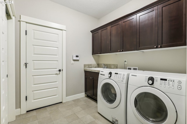 washroom featuring washer and clothes dryer, light tile patterned floors, cabinets, and sink