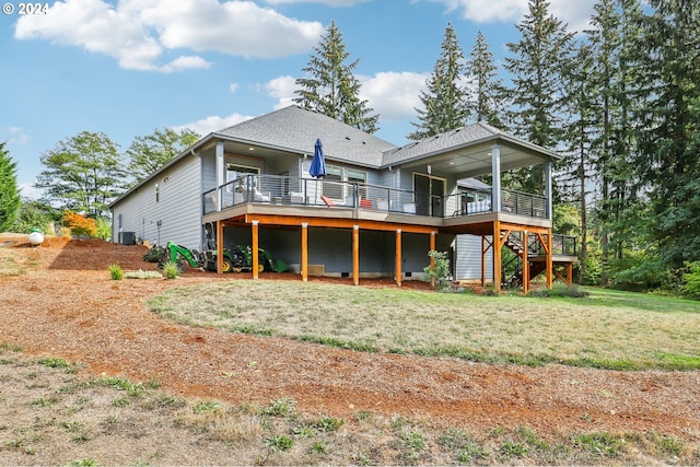 rear view of property with a yard, central AC unit, and a wooden deck