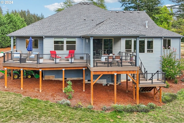 rear view of property featuring a deck