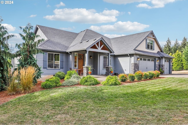 craftsman house featuring a front yard and a garage