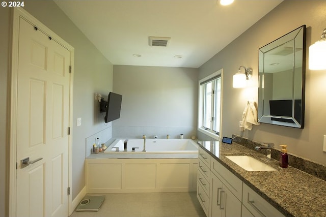 bathroom with vanity and a tub