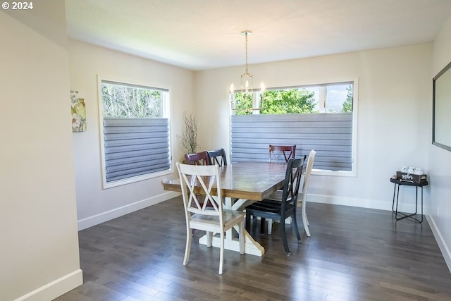 dining space featuring plenty of natural light, a chandelier, and dark hardwood / wood-style flooring