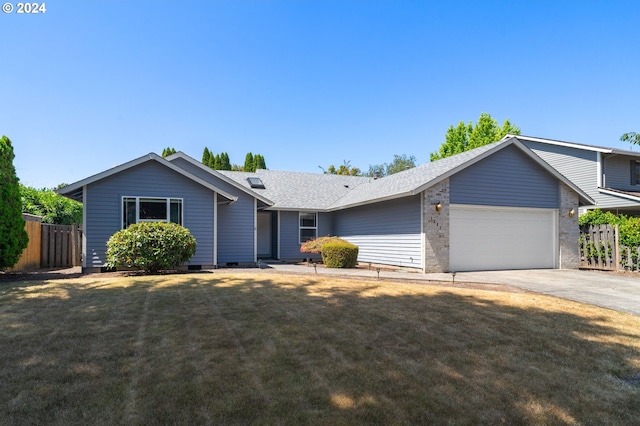 ranch-style home featuring a garage and a front lawn