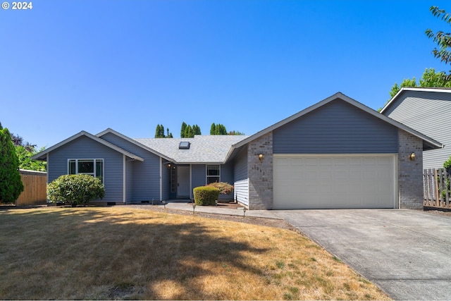 ranch-style home featuring a garage and a front yard