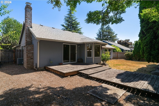 back of house featuring a yard, a wooden deck, and cooling unit